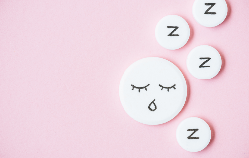Melatonin And Fertility-sleeping Faces On Tablets On Pink Background